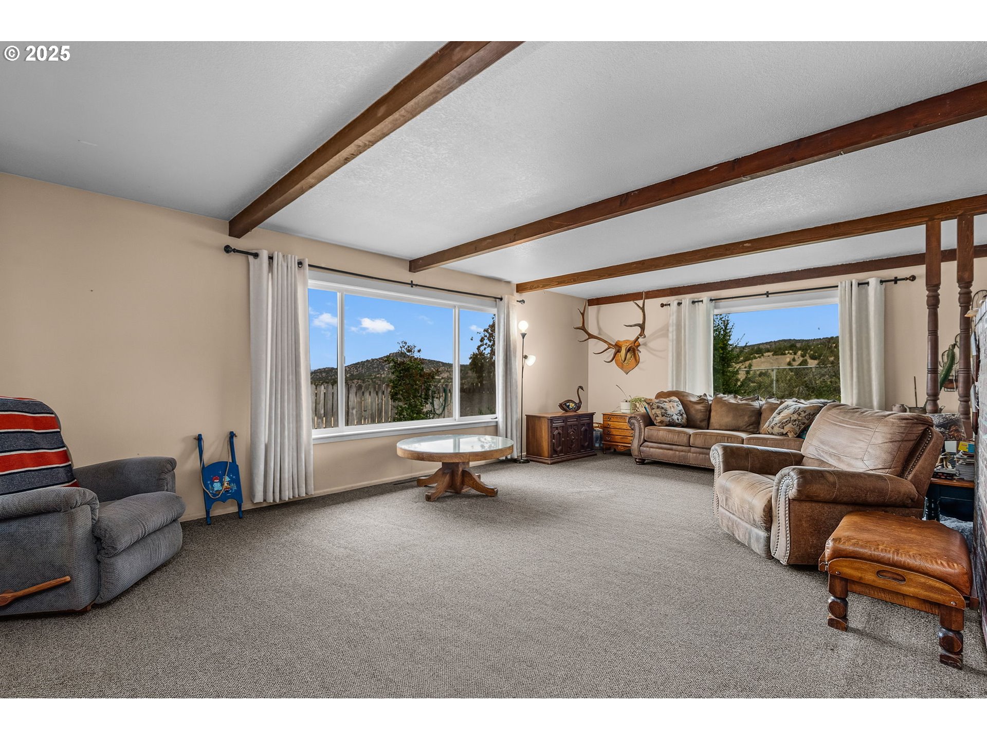 19369 Highway 26 Mitchell, OR 97750 - Photo 8 of 48 a living room with furniture a flat screen tv and a large window