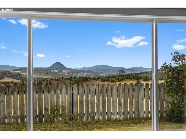 a view of a balcony with a forest