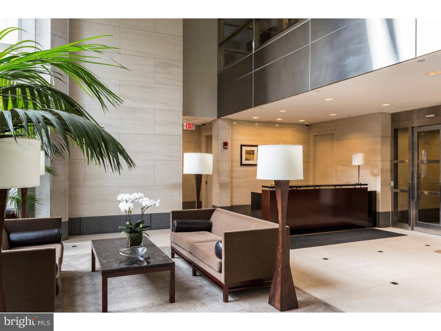 1706 Rittenhouse Square, Unit 402 Philadelphia, PA 19103 - Photo 2 of 17 a living room with furniture and a flat screen tv
