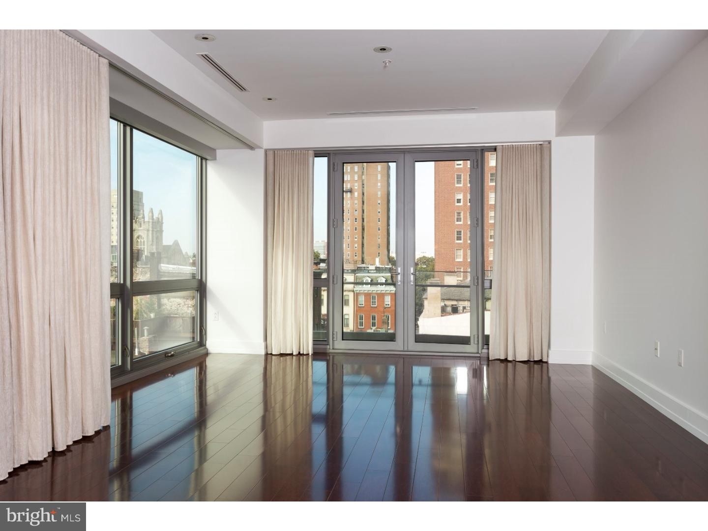 1706 Rittenhouse Square, Unit 402 Philadelphia, PA 19103 - Photo 13 of 17 a view of an empty room with wooden floor and a window