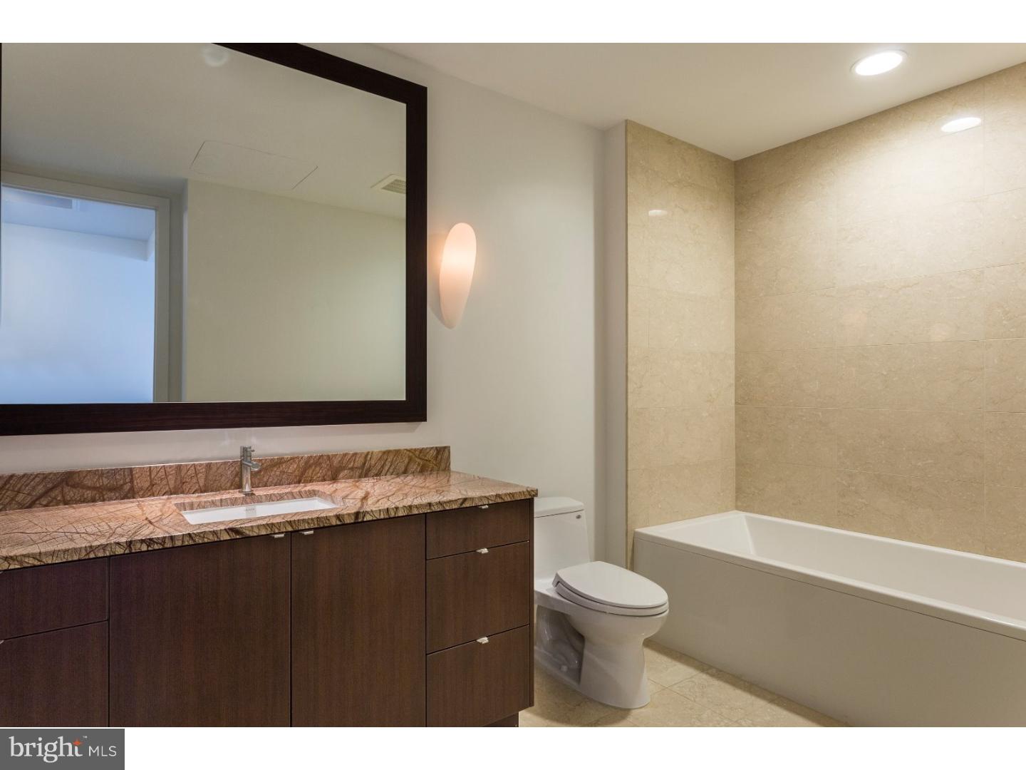 1706 Rittenhouse Square, Unit 402 Philadelphia, PA 19103 - Photo 6 of 17 a bathroom with a granite countertop sink toilet a mirror and shower