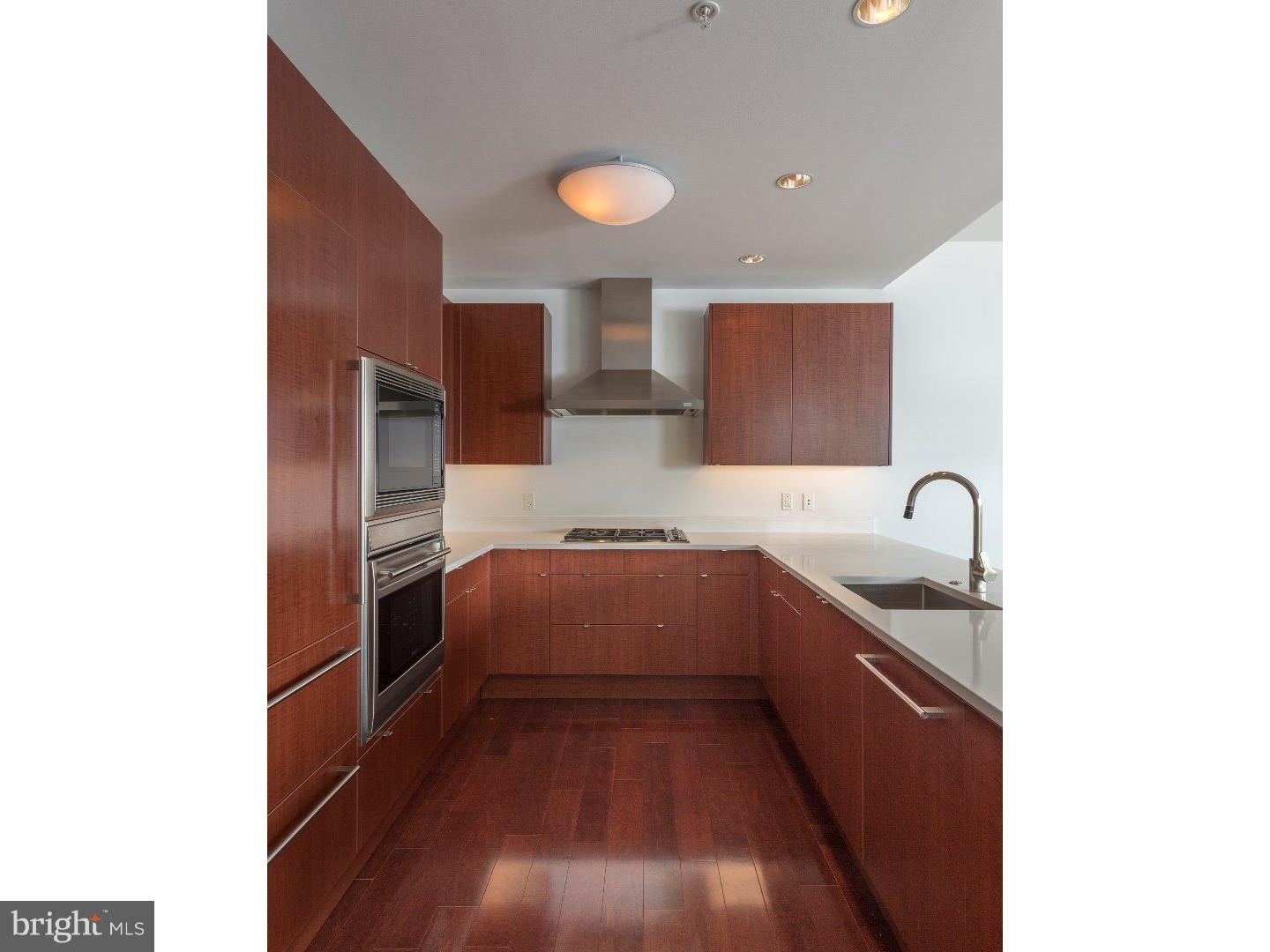 1706 Rittenhouse Square, Unit 402 Philadelphia, PA 19103 - Photo 7 of 17 a kitchen with stainless steel appliances granite countertop a sink and cabinets