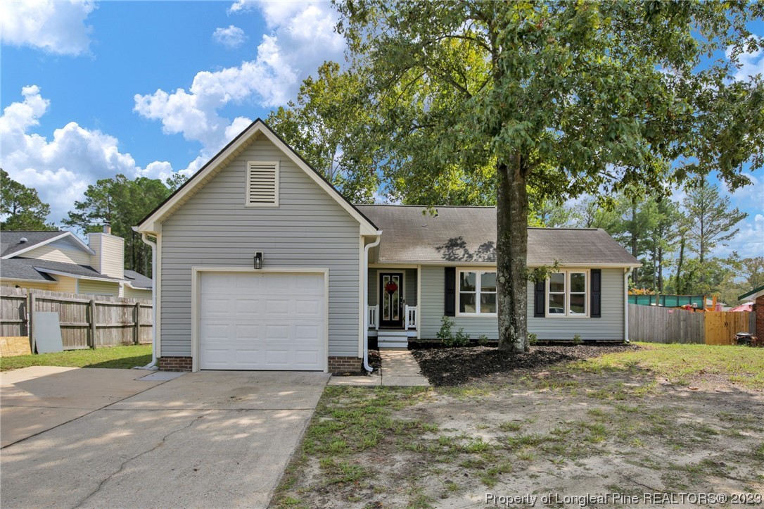 1163 Hoke Loop Road Fayetteville, NC 28314 - Photo 1 of 34 a front view of a house with a yard and garage