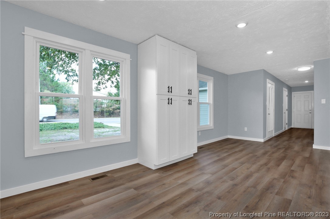 1163 Hoke Loop Road Fayetteville, NC 28314 - Photo 15 of 34 a view of an empty room with wooden floor and a window