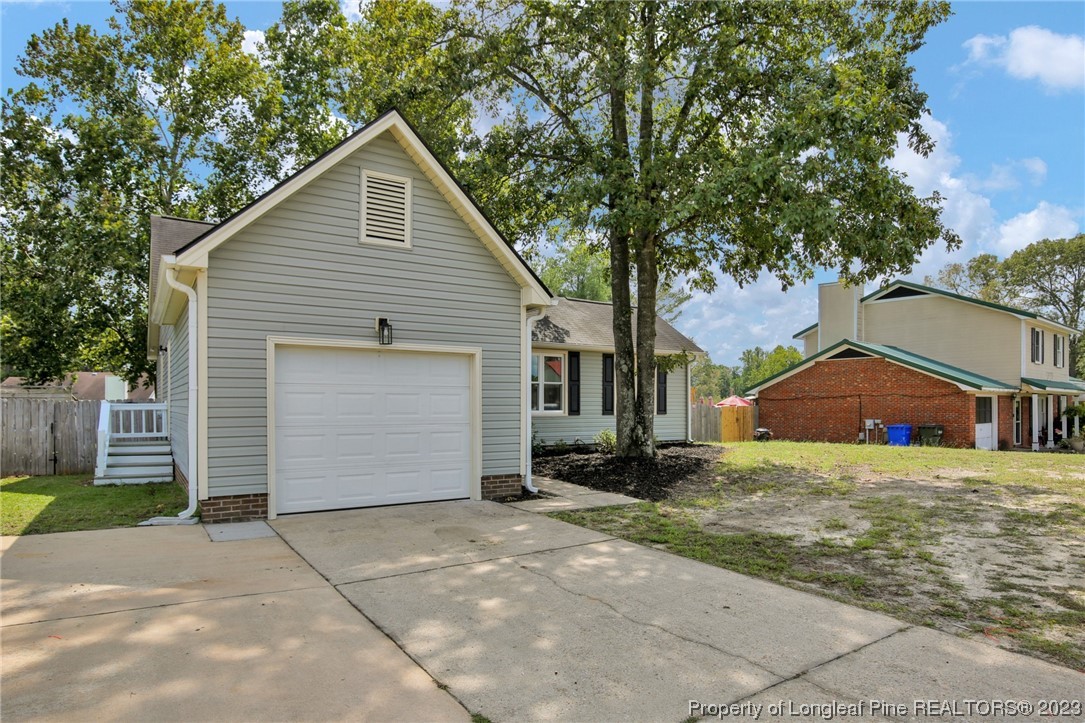1163 Hoke Loop Road Fayetteville, NC 28314 - Photo 2 of 34 a front view of a house with a yard and garage