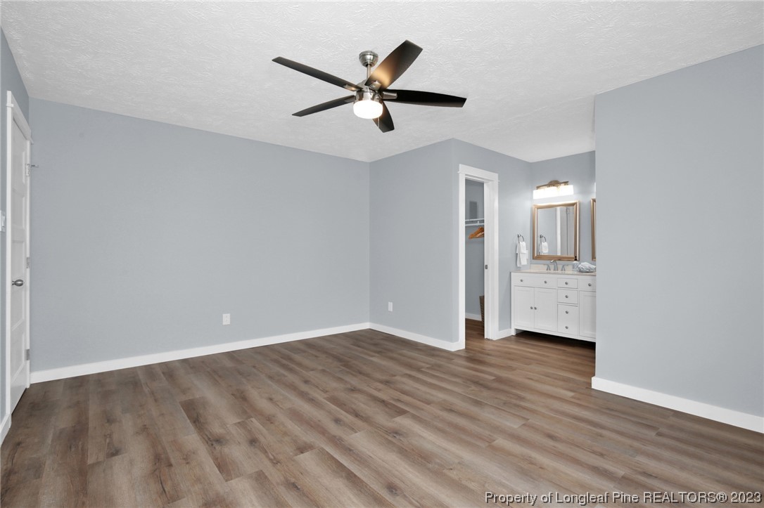 1163 Hoke Loop Road Fayetteville, NC 28314 - Photo 22 of 34 wooden floor in an empty room with a window