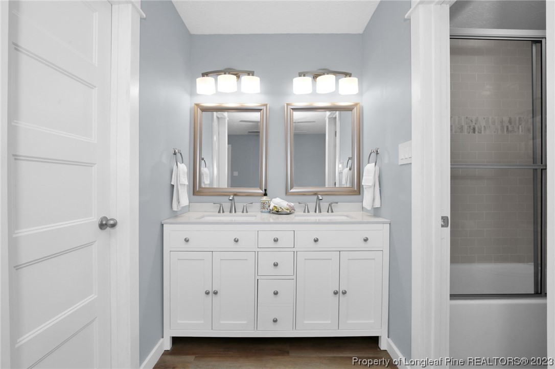 1163 Hoke Loop Road Fayetteville, NC 28314 - Photo 23 of 34 a bathroom with double vanity and a mirror