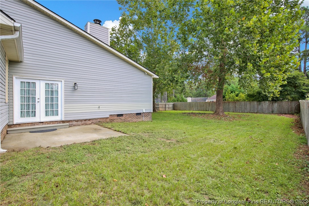 1163 Hoke Loop Road Fayetteville, NC 28314 - Photo 29 of 34 a backyard of a house with lots of green space