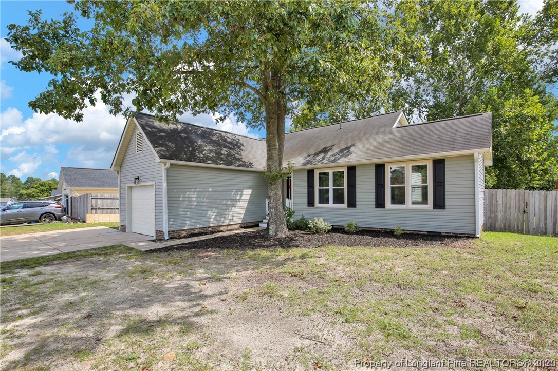 1163 Hoke Loop Road Fayetteville, NC 28314 - Photo 3 of 34 a view of a house with a yard and large tree