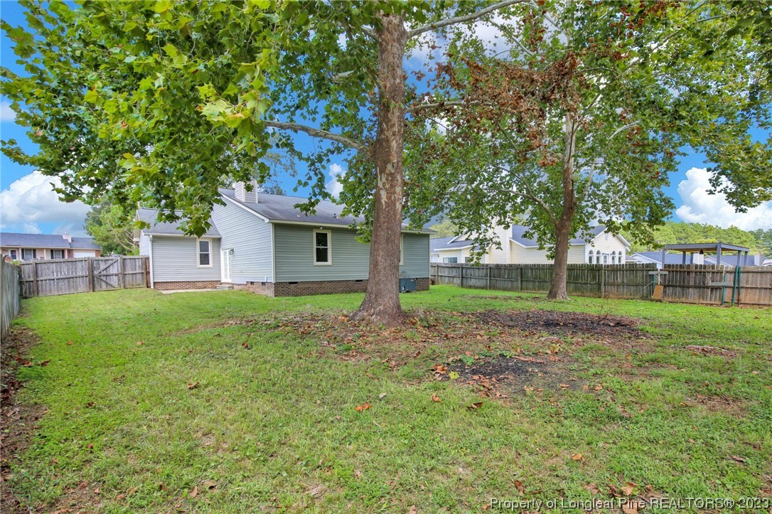 1163 Hoke Loop Road Fayetteville, NC 28314 - Photo 32 of 34 a view of a house with backyard and a tree