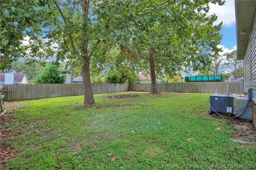 1163 Hoke Loop Road Fayetteville, NC 28314 - Photo 34 of 34 a view of a backyard with a garden and trees