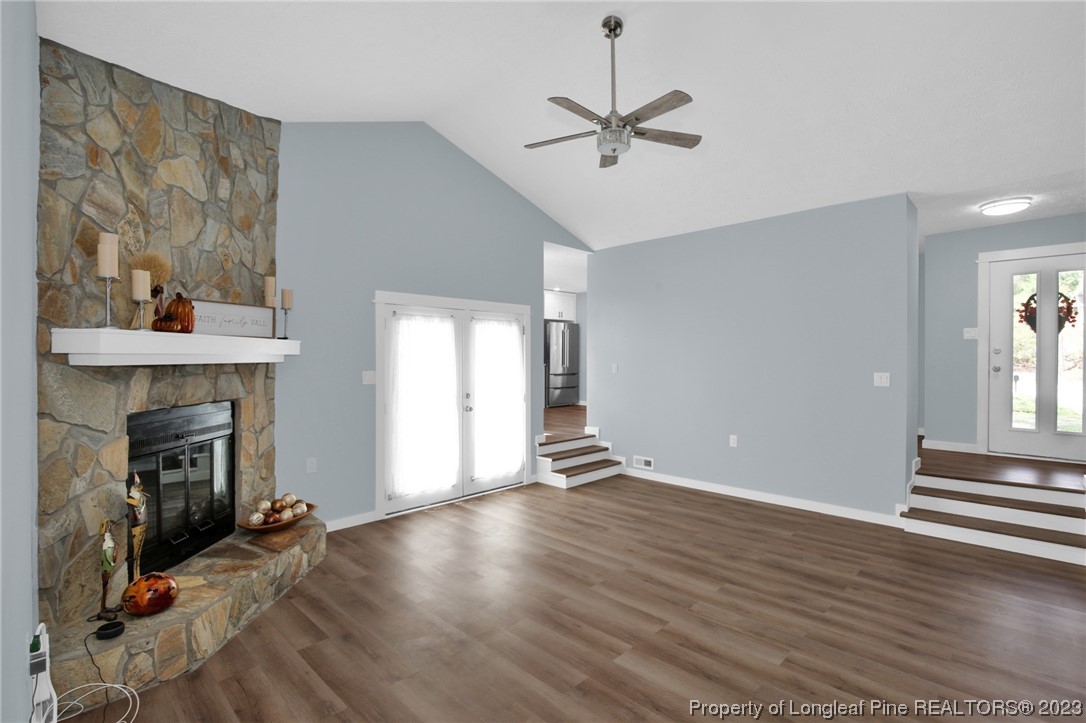 1163 Hoke Loop Road Fayetteville, NC 28314 - Photo 7 of 34 a view of an empty room with wooden floor fireplace and a window