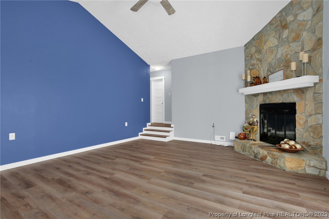1163 Hoke Loop Road Fayetteville, NC 28314 - Photo 9 of 34 a view of empty room with wooden floor and fireplace