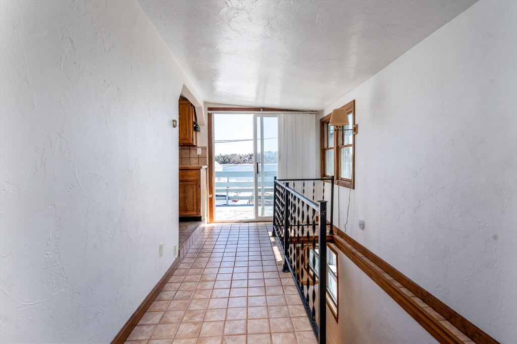 25 Nautical Way, Unit E Bourne, MA 02532 - Photo 17 of 25 a view of a hallway with wooden floor and staircase