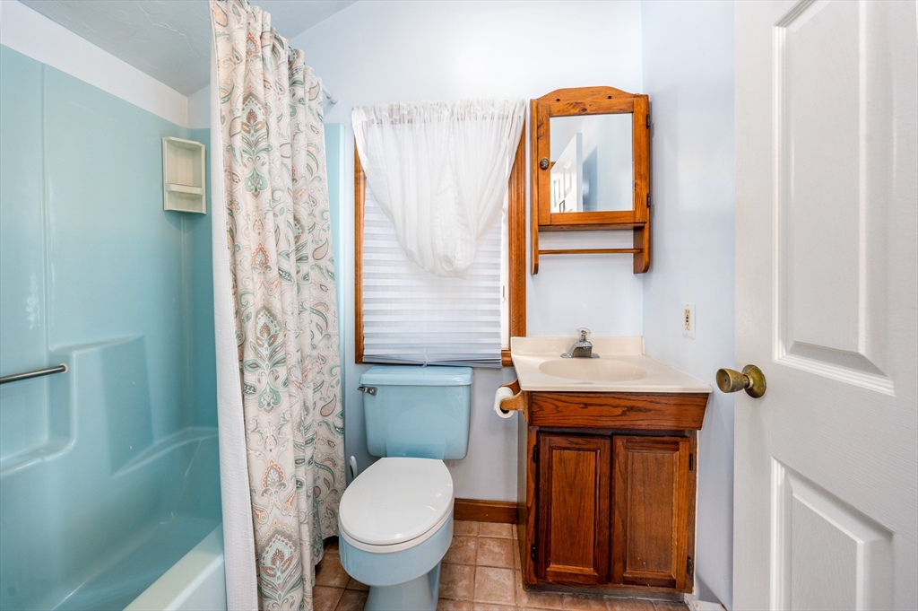 25 Nautical Way, Unit E Bourne, MA 02532 - Photo 9 of 25 a bathroom with a toilet sink and mirror