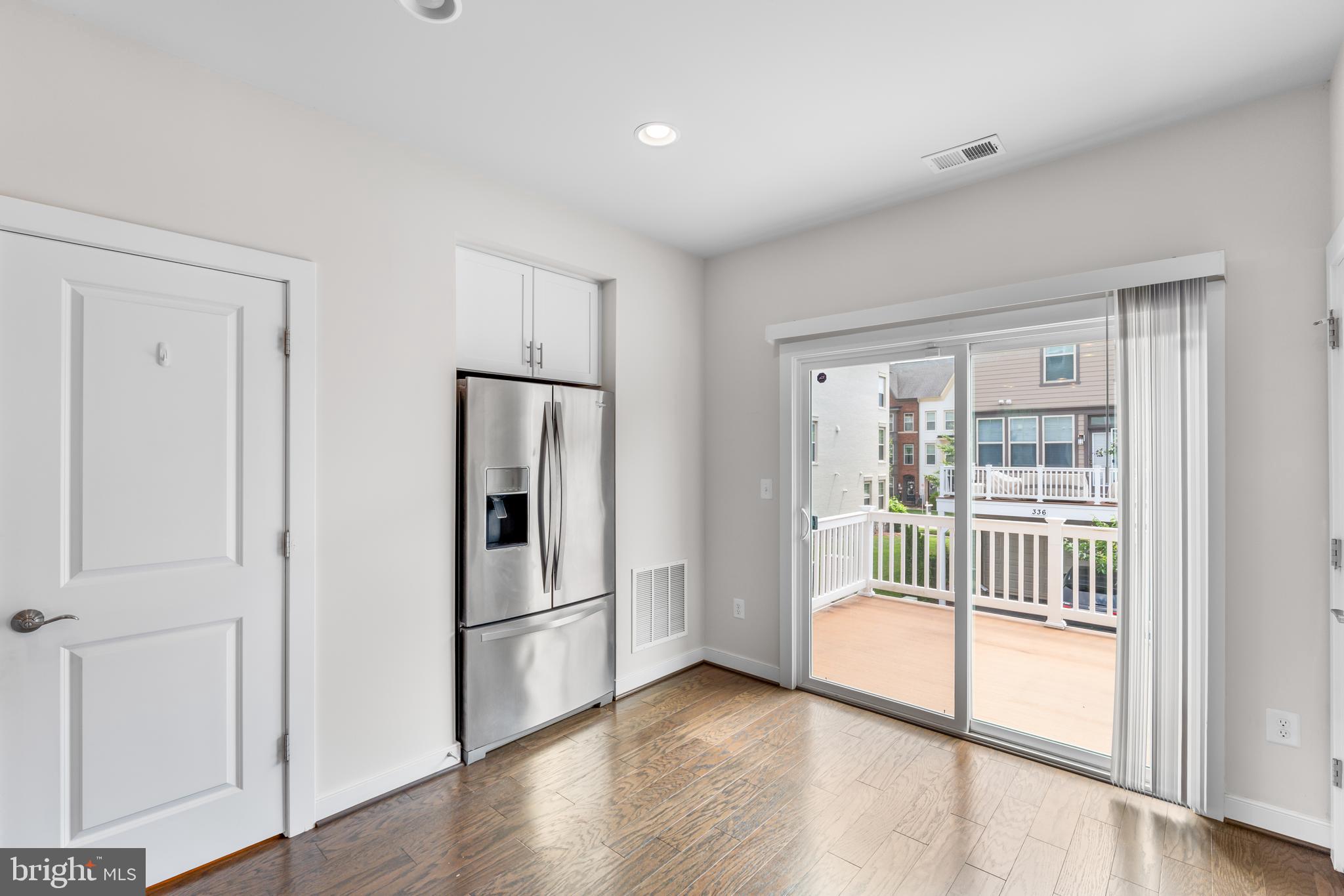 9780 Fields Road Gaithersburg, MD 20878 - Photo 11 of 37 a view of empty room with wooden floor and fan