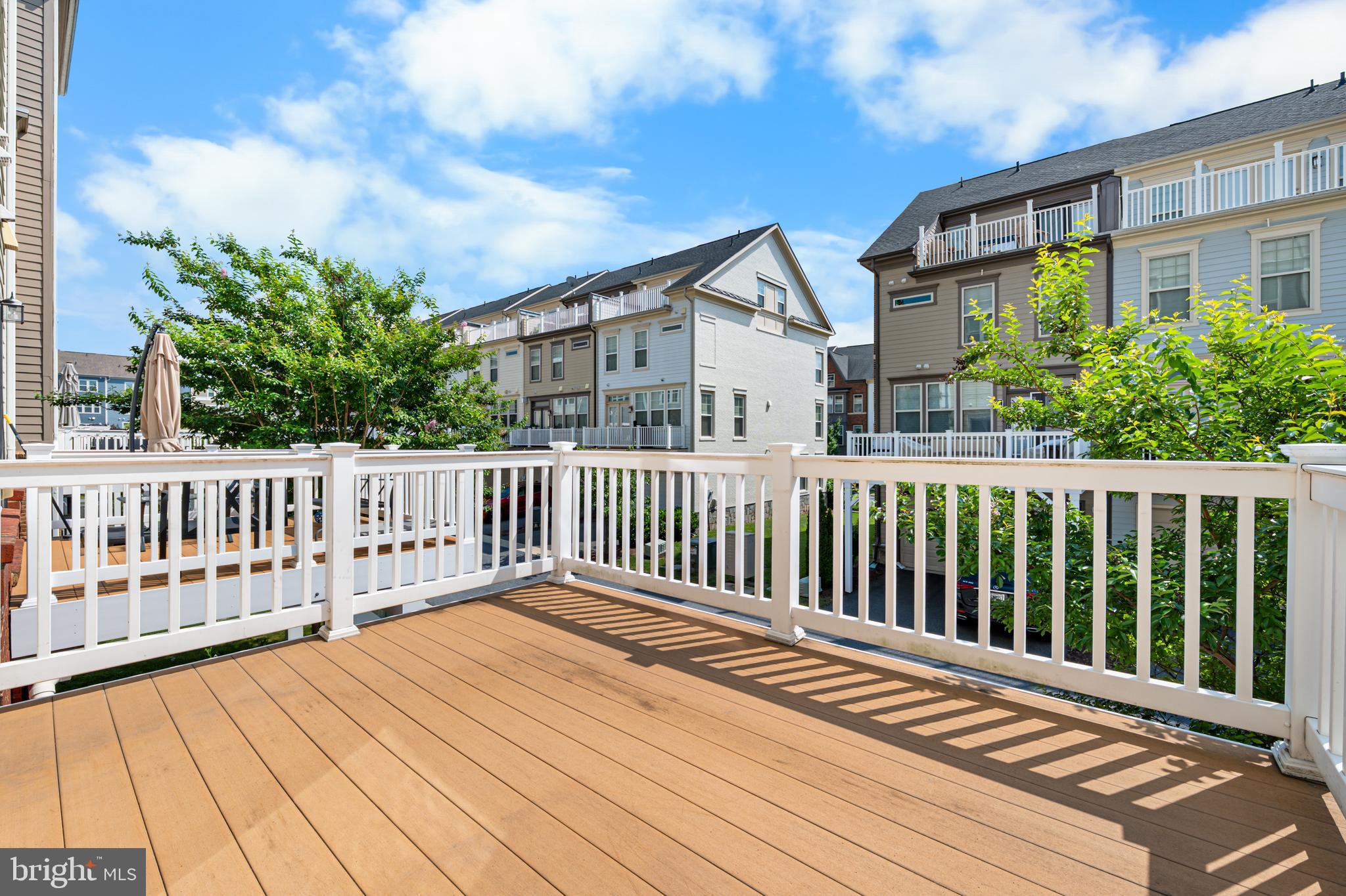9780 Fields Road Gaithersburg, MD 20878 - Photo 35 of 37 a balcony view with wooden floor and fence