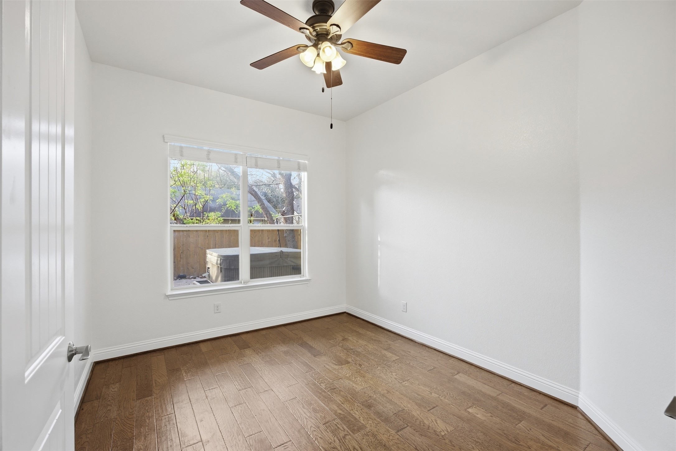 13600 Hymeadow Circle Austin, TX 78729 - Photo 17 of 34 an empty room with a window and a fan