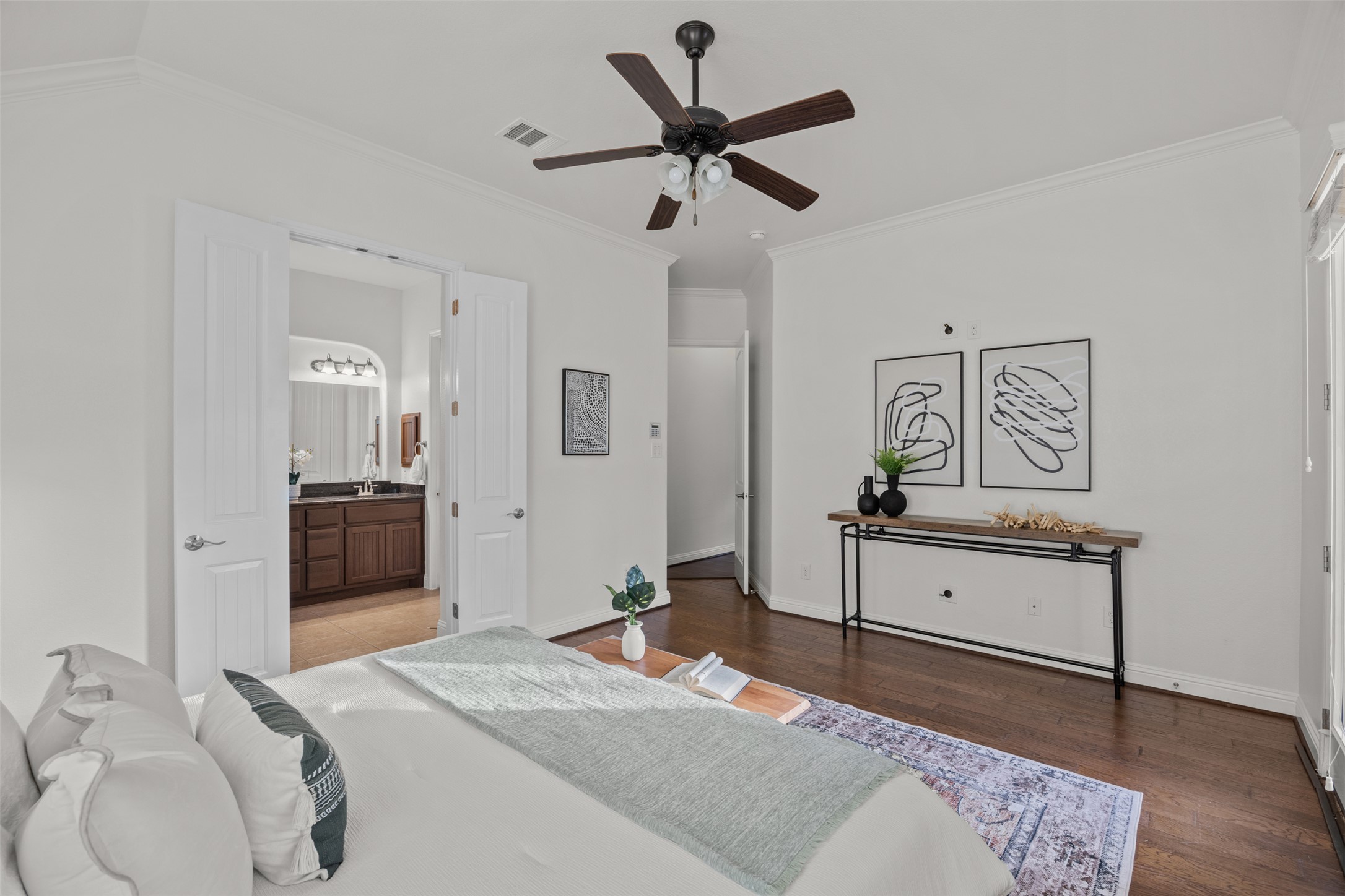 13600 Hymeadow Circle Austin, TX 78729 - Photo 19 of 34 a bedroom with a bed and a chandelier