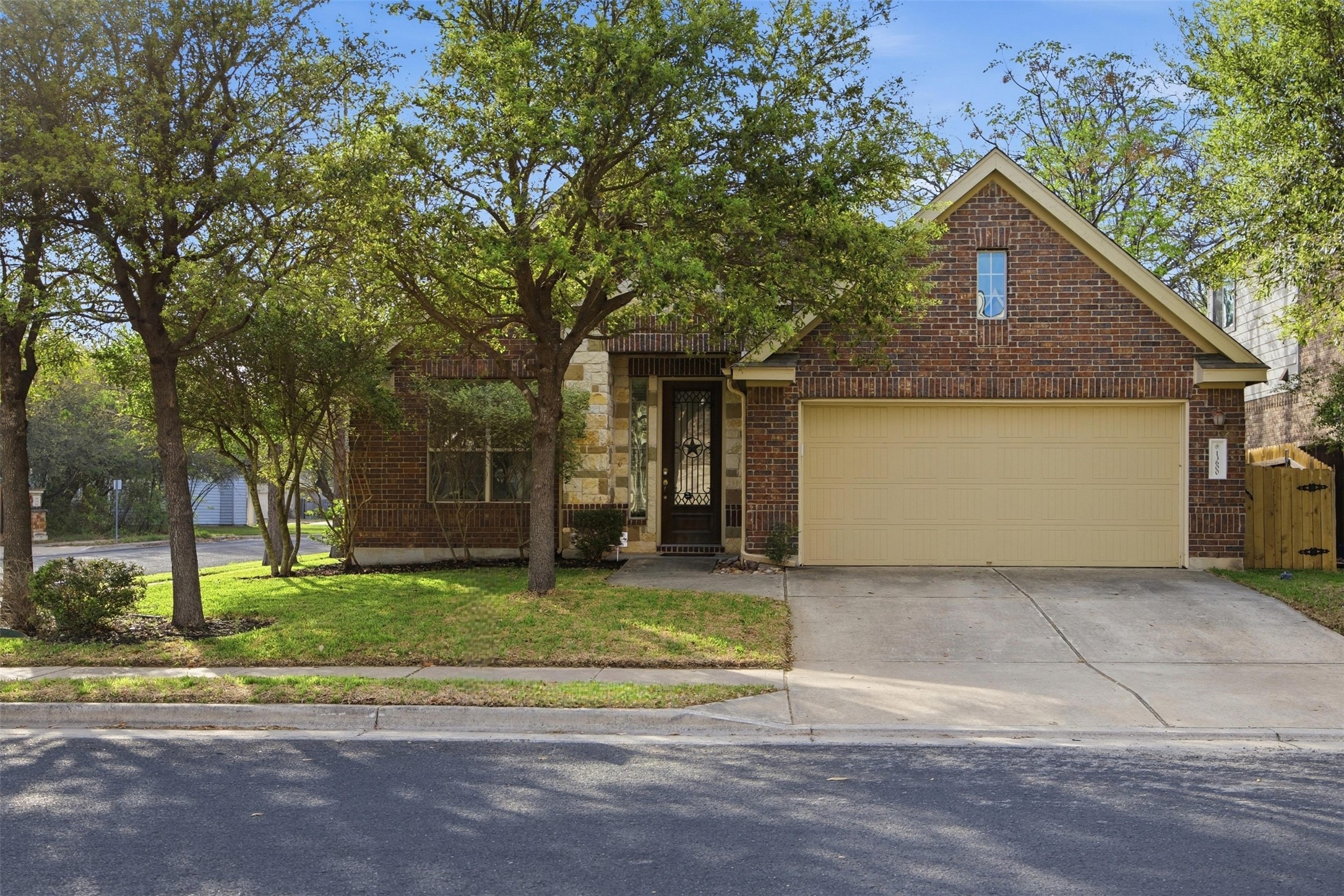 13600 Hymeadow Circle Austin, TX 78729 - Photo 2 of 34 a front view of a house with a yard and garage