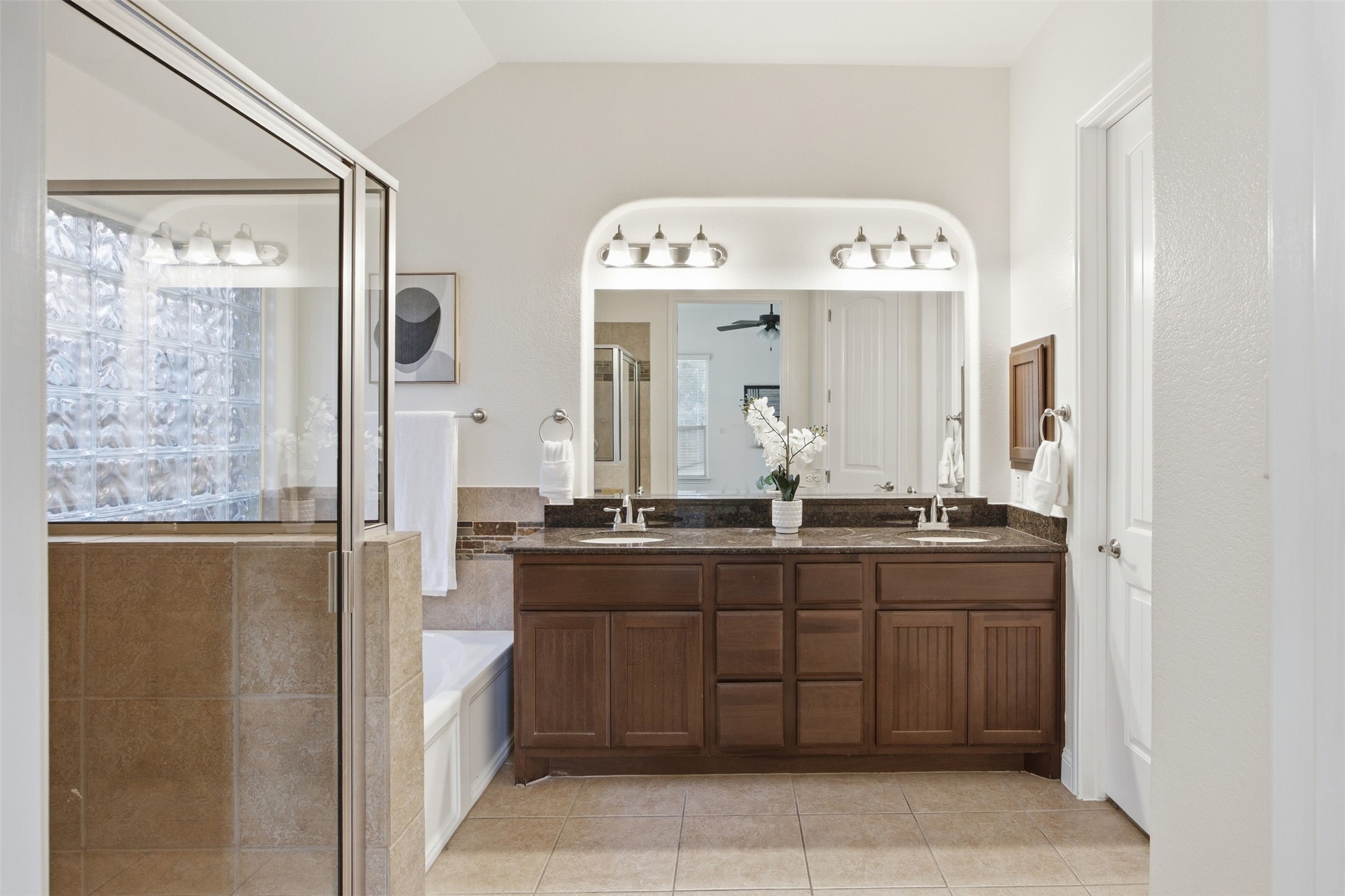 13600 Hymeadow Circle Austin, TX 78729 - Photo 22 of 34 a bathroom with a granite countertop sink a large mirror and a bathtub
