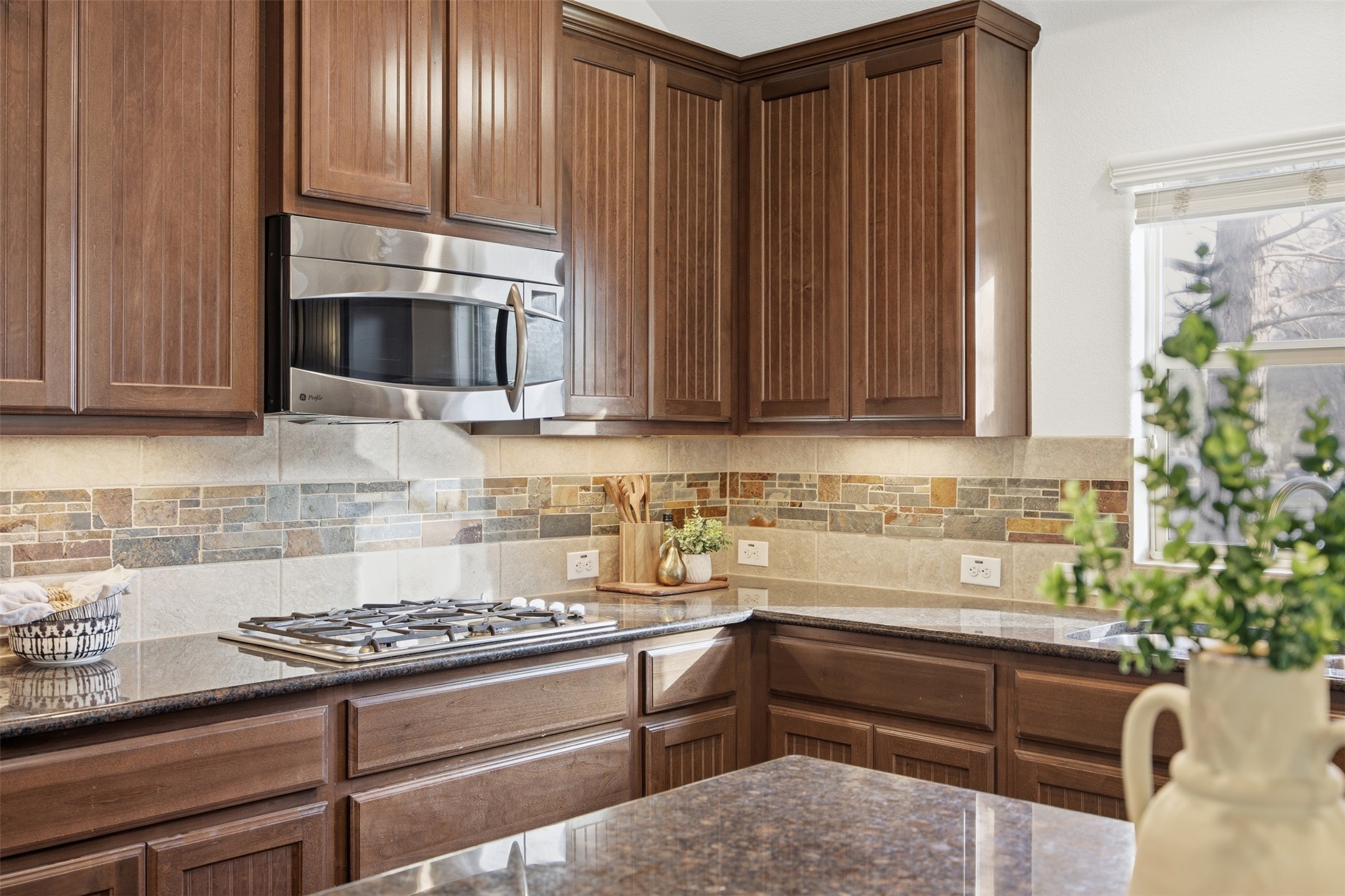 13600 Hymeadow Circle Austin, TX 78729 - Photo 6 of 34 a kitchen with stainless steel appliances granite countertop a stove a microwave and cabinets
