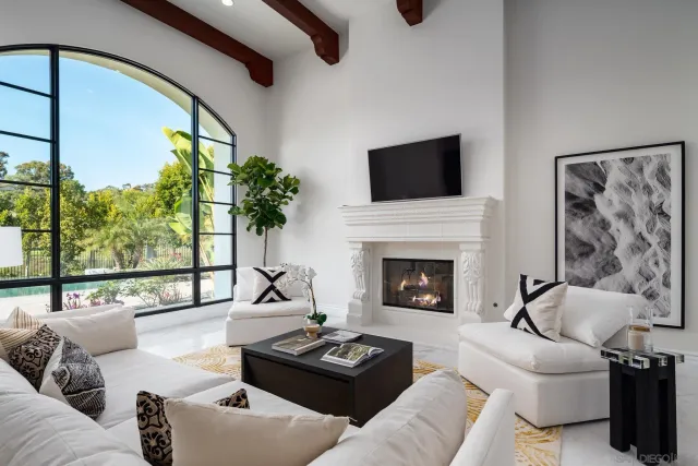 a living room with furniture fireplace and window