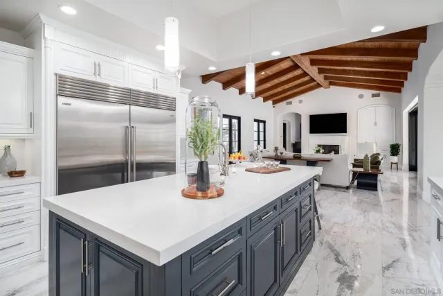 a kitchen with a sink a counter and chairs