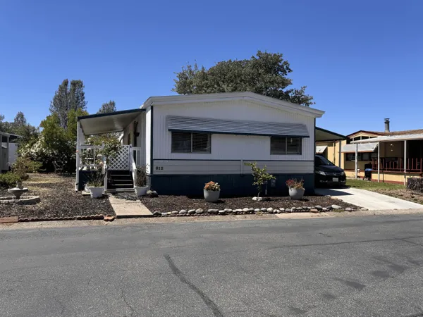a view of house with outdoor space and porch
