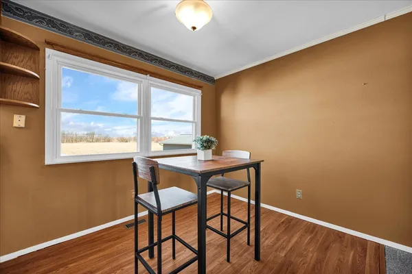 a view of a dining room with furniture and wooden floor