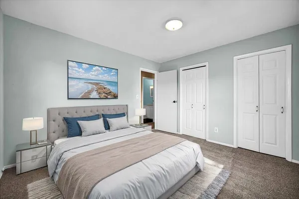 a bedroom with a bed and a dresser in it