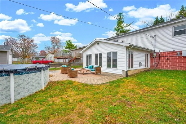 a view of a house with swimming pool and a yard