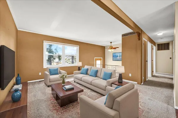 a living room with furniture and a flat screen tv