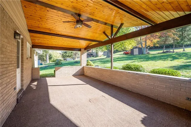 a view of a porch with wooden floor and fence