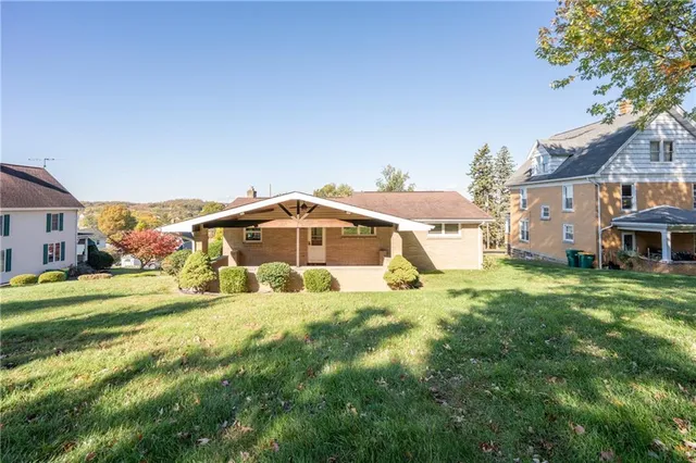 a big house with a big yard and large trees