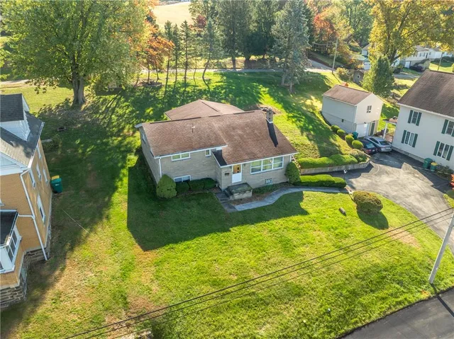an aerial view of a house with a swimming pool