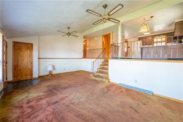 a view of a livingroom with a ceiling fan and window