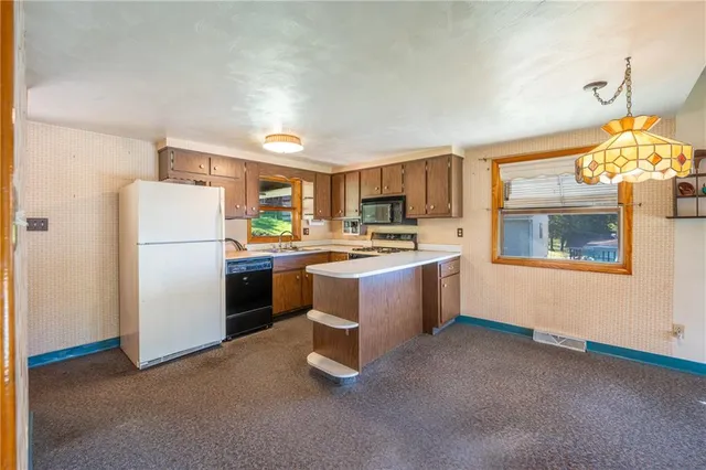 a kitchen with refrigerator cabinets and window