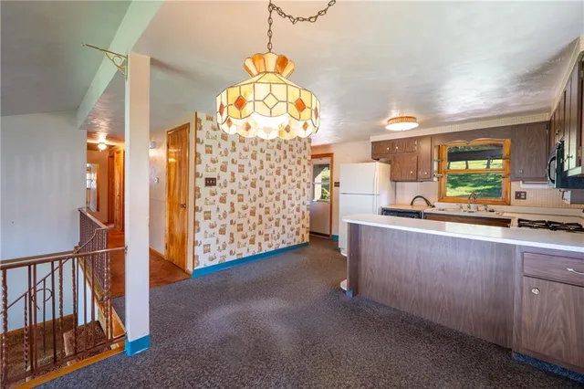 a view of a room with wooden floor windows and a chandelier