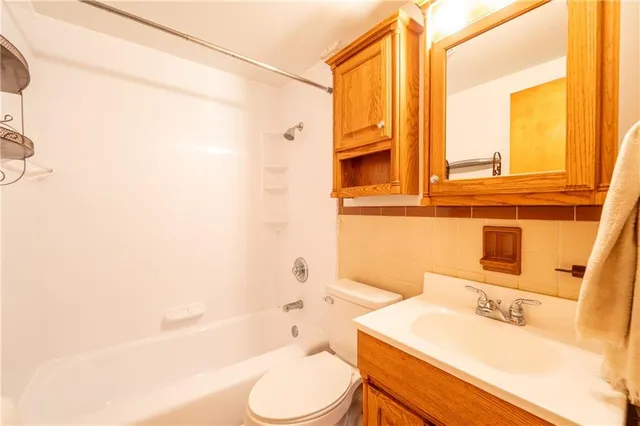 a bathroom with a sink a toilet and tub