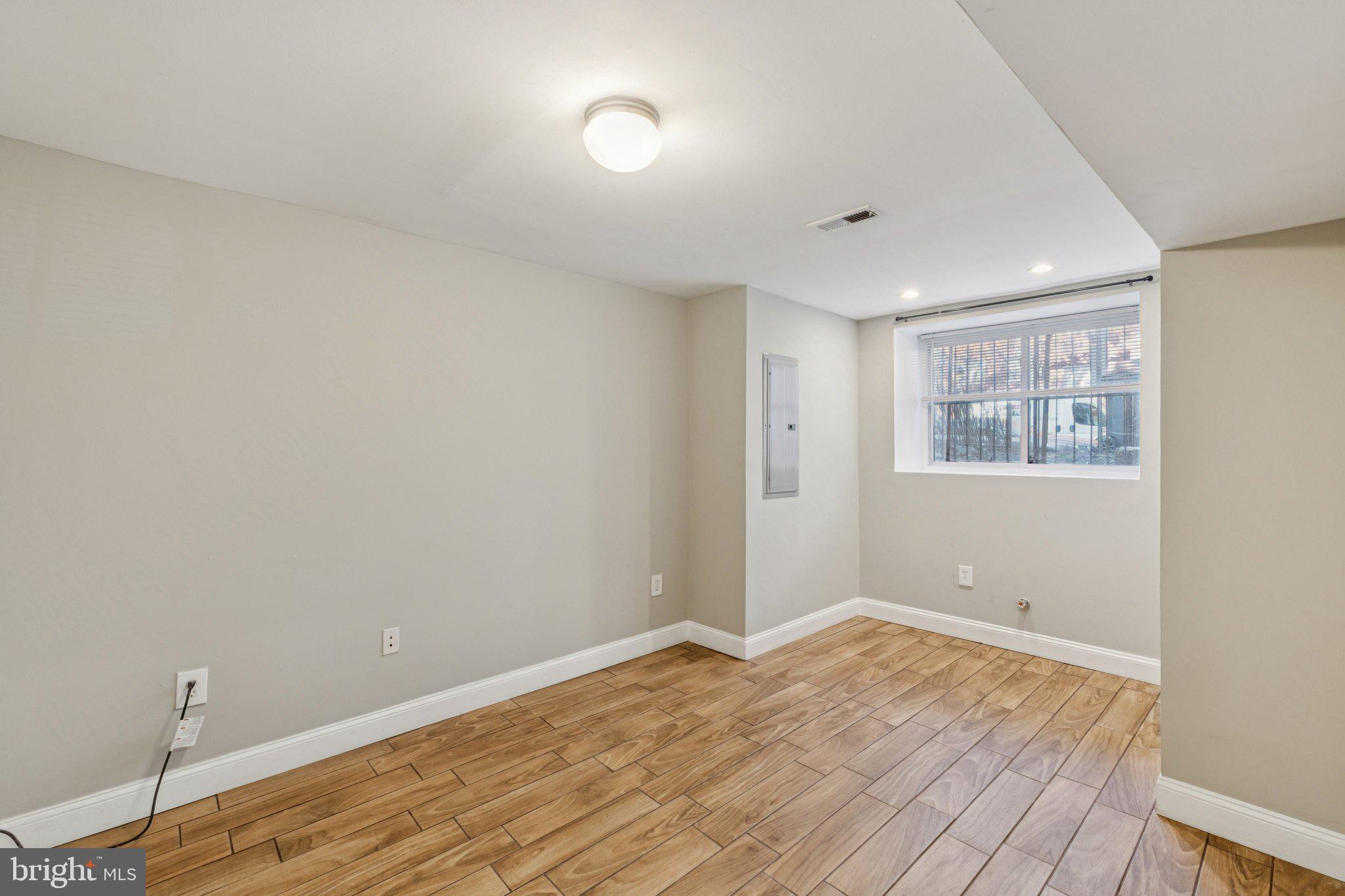 1440 Fairmont Street Northwest, Unit 1 Washington, DC 20009 - Photo 15 of 21 a view of empty room with wooden floor