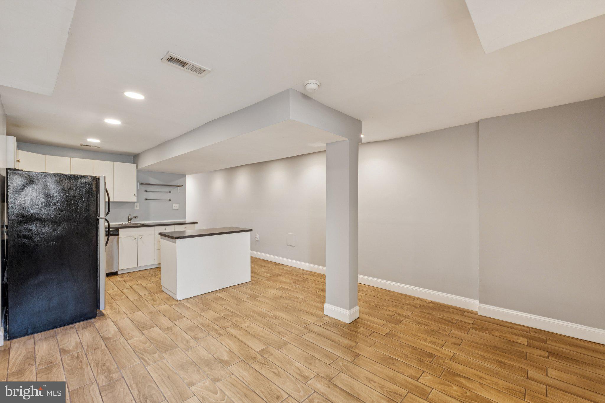 1440 Fairmont Street Northwest, Unit 1 Washington, DC 20009 - Photo 7 of 21 a view of kitchen with refrigerator and microwave