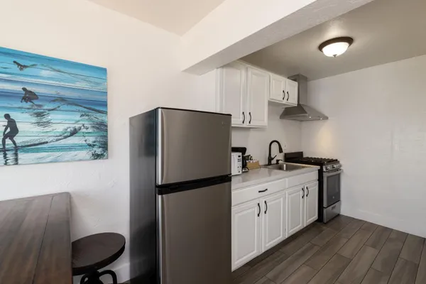 a kitchen with stainless steel appliances a refrigerator sink and stove