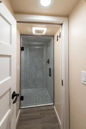 a bathroom with a glass shower door