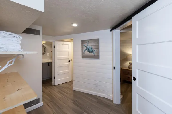 a view of walk in closet with wooden floor
