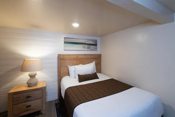 a bedroom with a bed and a night stand