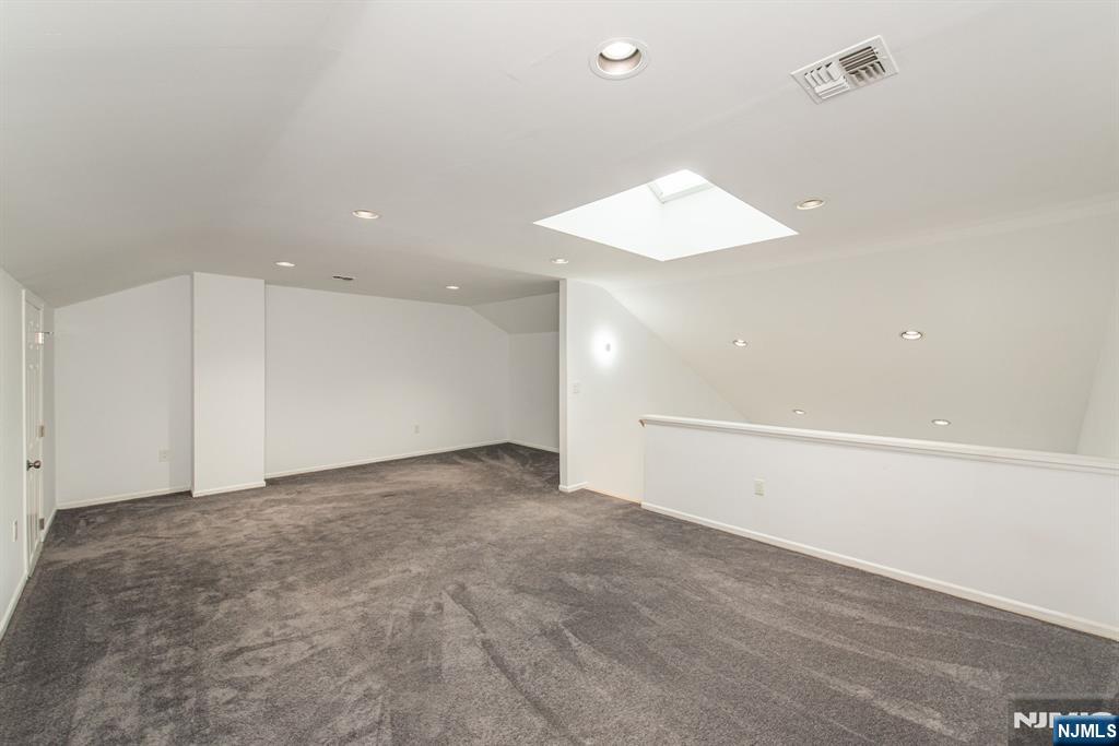 69 Amethyst Lane, Unit 283 Paterson, NJ 07501 - Photo 17 of 20 an empty room with an entryway and fan