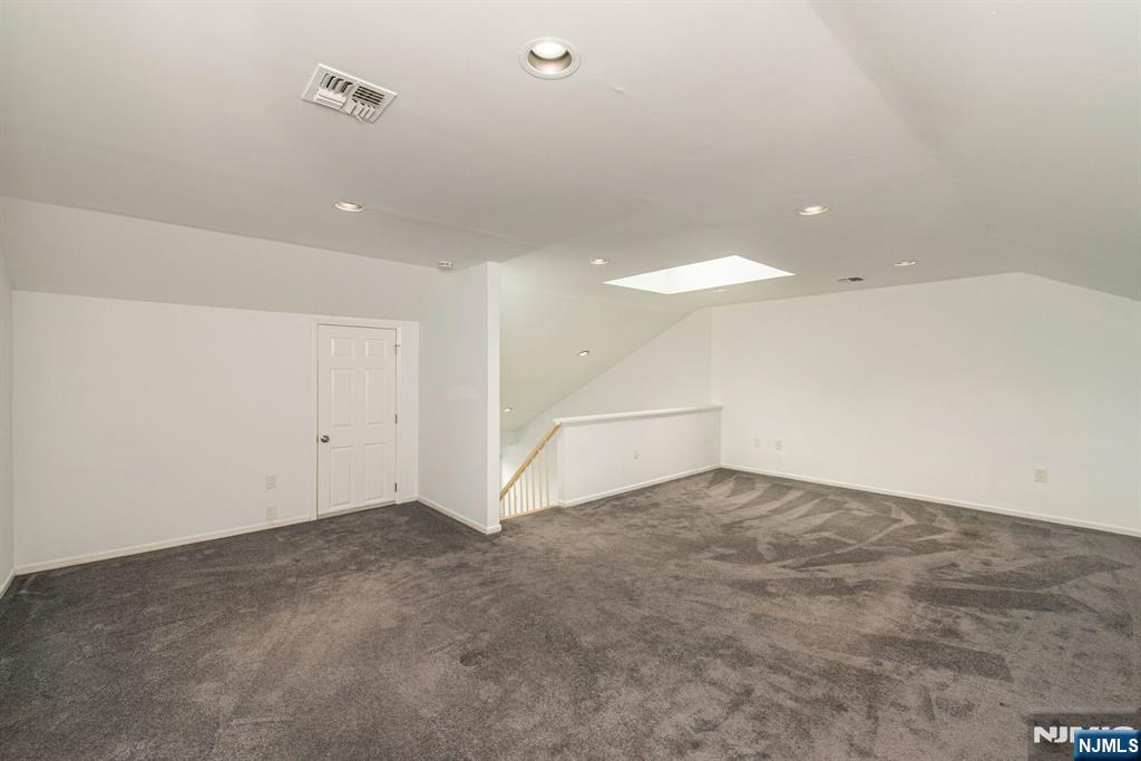 69 Amethyst Lane, Unit 283 Paterson, NJ 07501 - Photo 18 of 20 an empty room with an entryway and fan