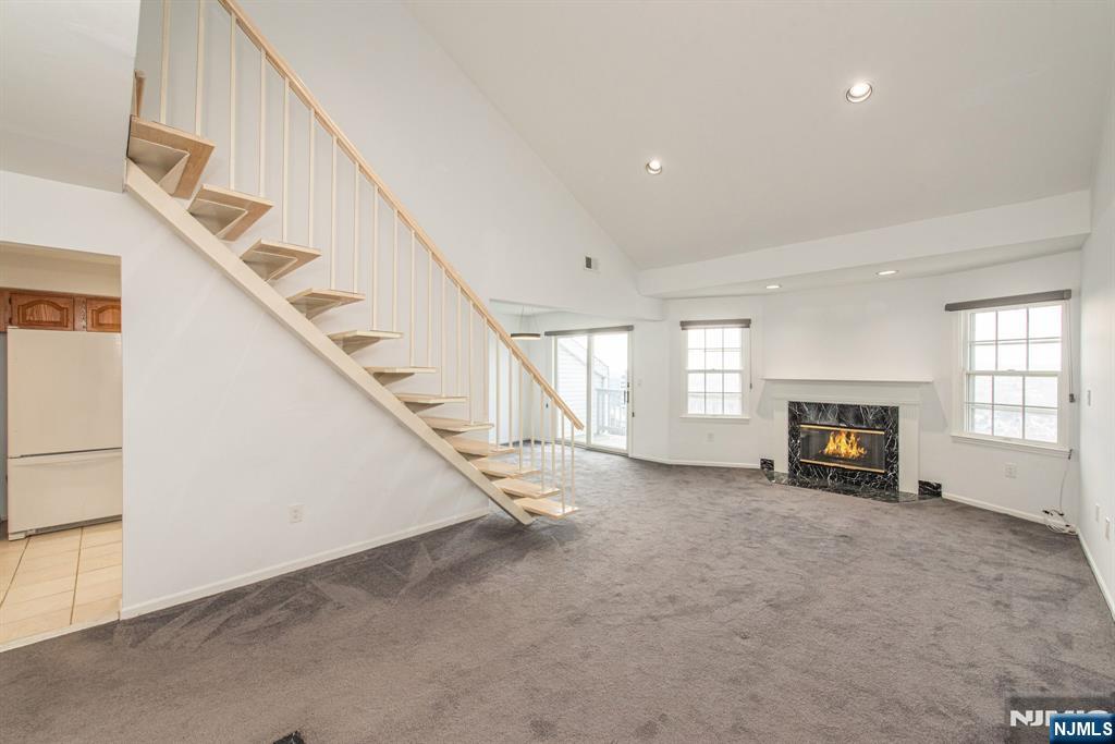 69 Amethyst Lane, Unit 283 Paterson, NJ 07501 - Photo 2 of 20 a view of an empty room with a fireplace