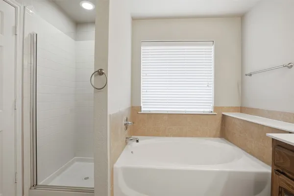 a bathroom with a bathtub and shower